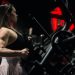Focused woman engaging in a strength training session at the gym using robust fitness machinery.